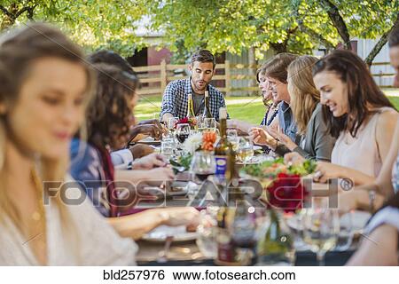 Friends enjoying wine at party outdoors View Large Photo Image Stock Photograph - Friends enjoying wine at party outdoors. Fotosearch