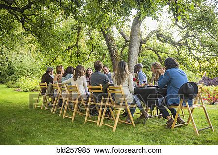 Friends enjoying wine at party outdoors View Large Photo Image Stock Photography - Friends enjoying wine at party outdoors. Fotosearch