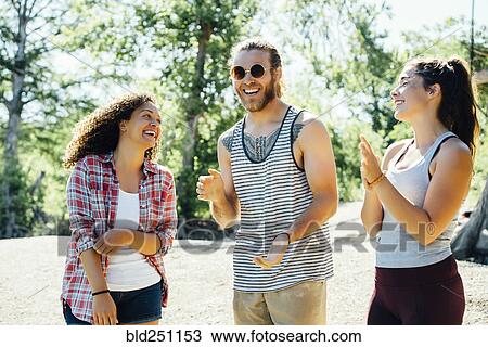 Stock Image - Friends laughing outdoors. Fotosearch