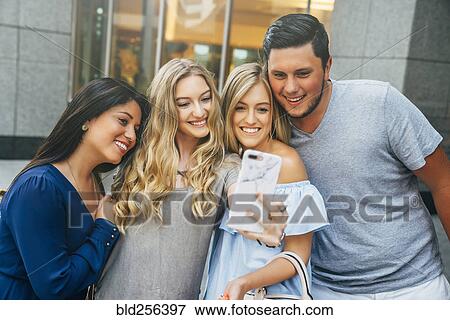 Friends posing for cell phone selfie View Large Photo Image Stock Photo - Friends posing for cell phone selfie. Fotosearch