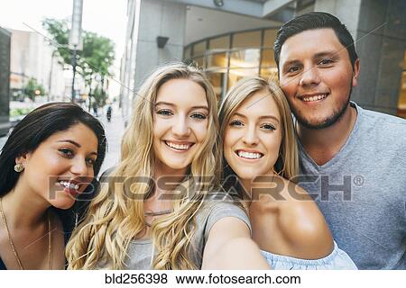 Friends posing for cell phone selfie View Large Photo Image Stock Photo - Friends posing for cell phone selfie. Fotosearch