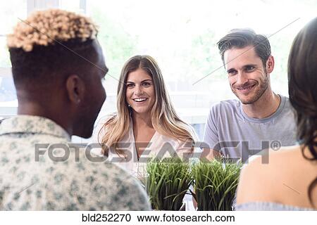Friends smiling and talking View Large Photo Image Stock Image - Friends smiling and talking. Fotosearch