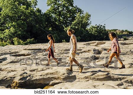 Friends walking on rocks View Large Photo Image Picture - Friends walking on rocks. Fotosearch