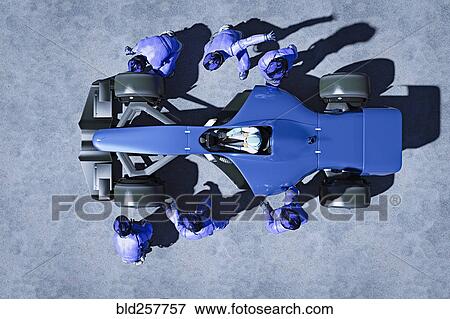 Futuristic pit crew servicing race car View Large Photo Image Stock Photo - Futuristic pit crew servicing race car. Fotosearch