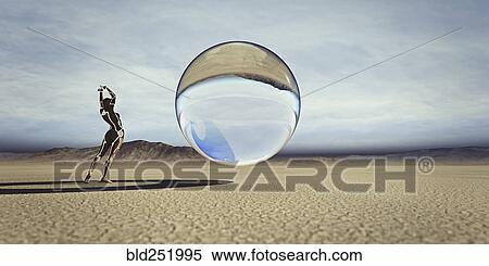 Stock Photography - Futuristic woman watching floating sphere in desert. Fotosearch