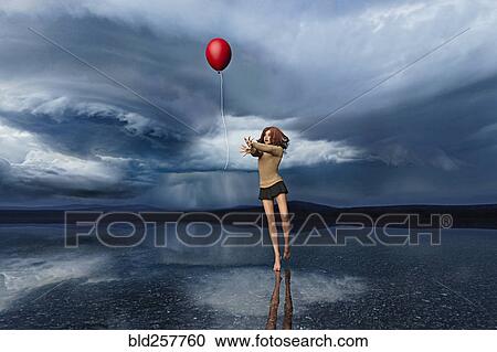 Stock Image - Girl chasing red balloon. Fotosearch