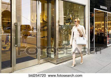 Stock Image - Glamorous Caucasian woman window shopping. Fotosearch