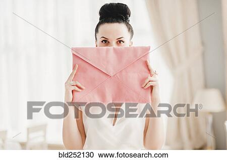 Glamorous Middle Eastern woman covering face with pink purse View Large Photo Image Stock Image - Glamorous Middle Eastern woman covering face with pink purse. Fotosearch