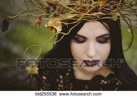 Stock Photograph - Gothic Caucasian woman wearing crown of branches. Fotosearch