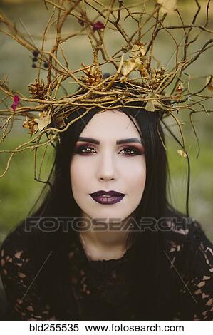 Stock Photography - Gothic Caucasian woman wearing crown of branches. Fotosearch