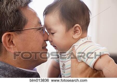 Stock Photograph - Grandfather giving Chinese grandson Eskimo kiss. Fotosearch