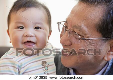 Grandfather smiling at Chinese grandson View Large Photo Image Stock Photography - Grandfather smiling at Chinese grandson. Fotosearch