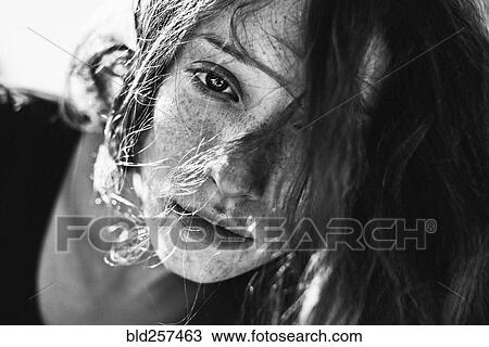 Stock Image - Hair covering face of Caucasian woman. Fotosearch