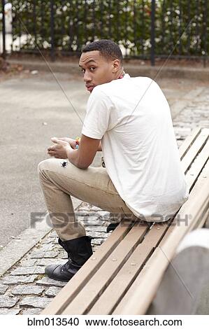 Haitian man sitting on bench View Large Photo Image Stock Image - Haitian man sitting on bench. Fotosearch