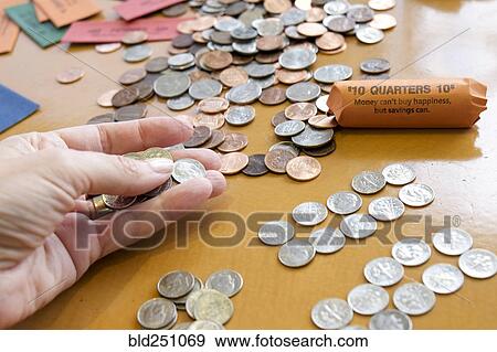 Stock Photo - Hand holding coins. Fotosearch