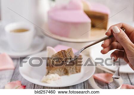 Hand of woman holding cake on fork View Large Photo Image Stock Image - Hand of woman holding cake on fork. Fotosearch