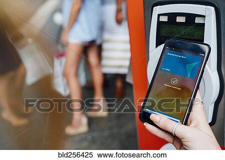 Hand of woman paying at kiosk using cell phone View Large Photo Image Stock Photography - Hand of woman paying at kiosk using cell phone. Fotosearch