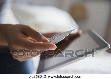 Hands of African American woman online shopping with digital tablet View Large Photo Image Stock Image - Hands of African American woman online shopping with digital tablet. Fotosearch