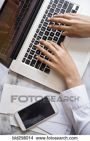 Hands of African American woman typing on laptop View Large Photo Image Picture - Hands of African American woman typing on laptop. Fotosearch