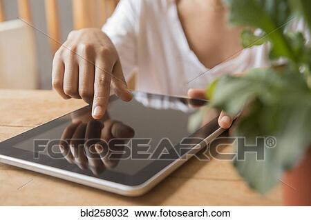 Hands of African American woman using digital tablet View Large Photo Image Stock Image - Hands of African American woman using digital tablet. Fotosearch