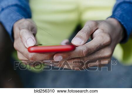 Hands of Black man texting on cell phone View Large Photo Image Stock Image - Hands of Black man texting on cell phone. Fotosearch