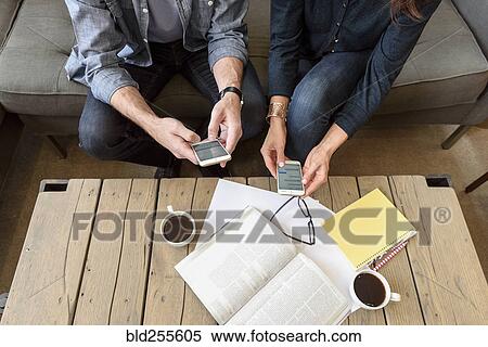 Hands of Caucasian couple texting on cell phones View Large Photo Image Stock Photography - Hands of Caucasian couple texting on cell phones. Fotosearch