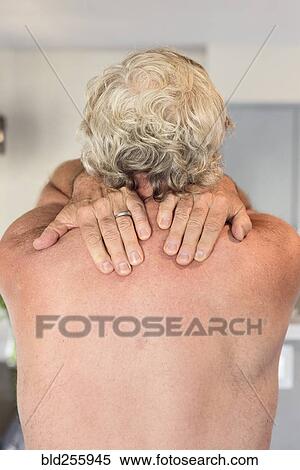 Stock Photography - Hands of Caucasian man rubbing shoulders. Fotosearch