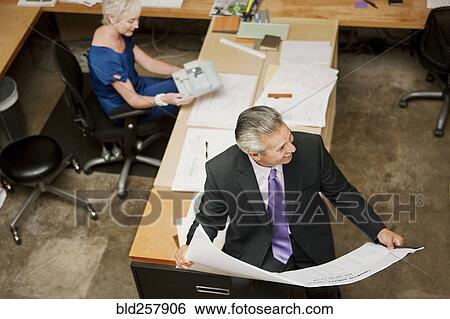 Stock Photograph - High angle view of architects working in office. Fotosearch