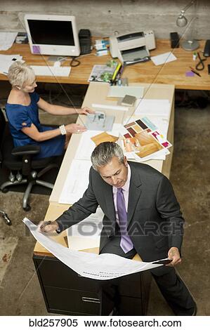 Stock Photography - High angle view of architects working in office. Fotosearch