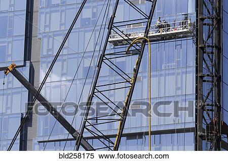 Stock Photography - Highrise window washers on scaffolding. Fotosearch