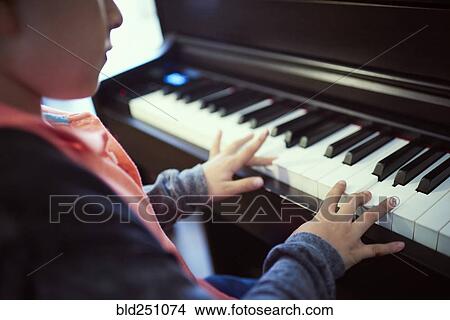 Hispanic boy playing piano View Large Photo Image Picture - Hispanic boy playing piano. Fotosearch