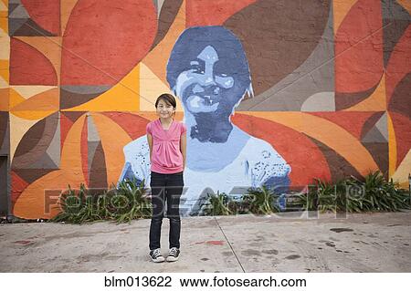 Hispanic girl standing near mural View Large Photo Image Stock Image - Hispanic girl standing near mural. Fotosearch