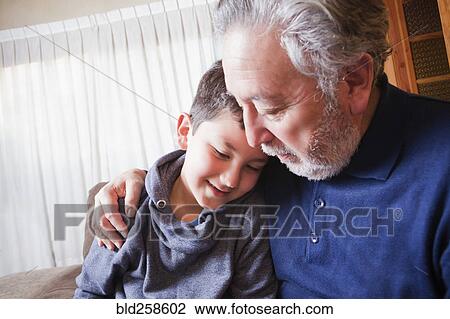 Hispanic grandfather hugging grandson View Large Photo Image Stock Image - Hispanic grandfather hugging grandson. Fotosearch