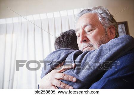 Hispanic grandfather hugging grandson View Large Photo Image Stock Photography - Hispanic grandfather hugging grandson. Fotosearch
