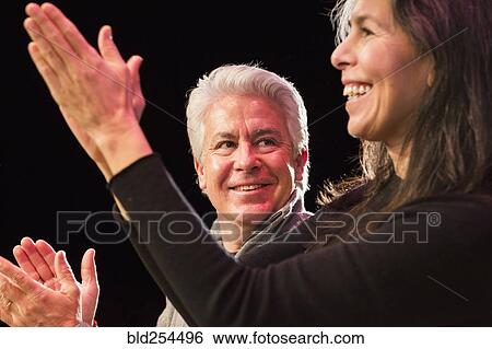 Hispanic man and woman clapping hands View Large Photo Image Stock Photograph - Hispanic man and woman clapping hands. Fotosearch