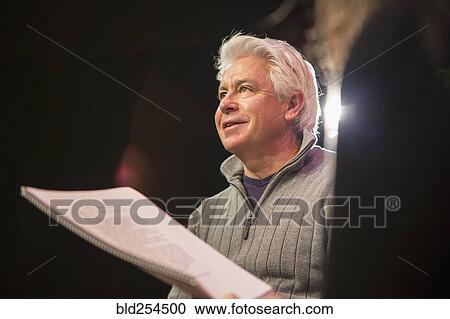 Hispanic man and woman reading scripts in theater View Large Photo Image Stock Image - Hispanic man and woman reading scripts in theater. Fotosearch