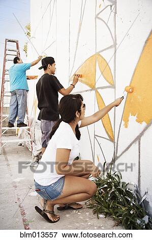 Stock Photo - Hispanic people painting wall. Fotosearch