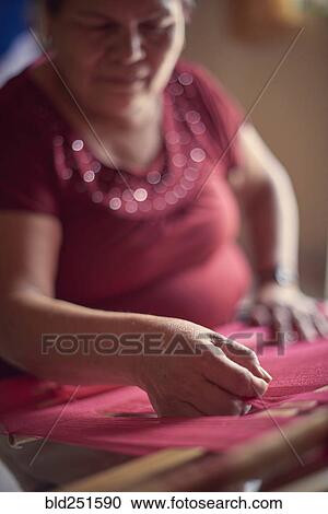 Hispanic woman weaving fabric on loom View Large Photo Image Stock Image - Hispanic woman weaving fabric on loom. Fotosearch