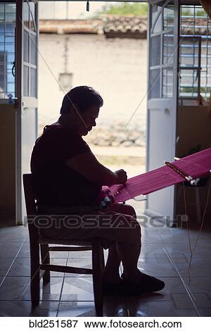 Hispanic woman weaving fabric on loom near doorway View Large Photo Image Stock Photo - Hispanic woman weaving fabric on loom near doorway. Fotosearch