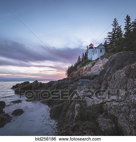 Stock Photograph - House on cliff near ocean at sunset. Fotosearch
