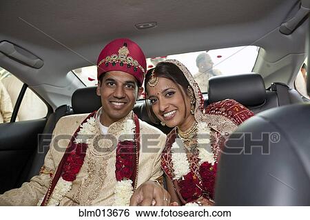 Indian bride and groom in traditional clothing in car View Large Photo Image Stock Photograph - Indian bride and groom in traditional clothing in car. Fotosearch