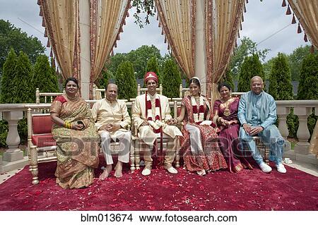 Picture - Indian bride and groom with family in traditional clothing. Fotosearch