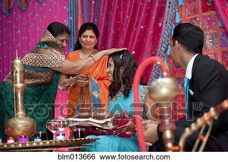 Indian woman blessing Indian bride View Large Photo Image Stock Photograph - Indian woman blessing Indian bride. Fotosearch