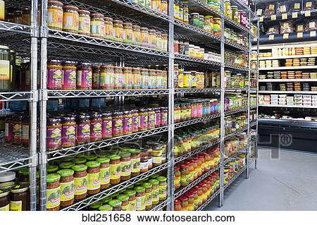 Jars of food in supermarket aisle View Large Photo Image Stock Photo - Jars of food in supermarket aisle. Fotosearch