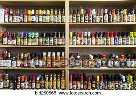 Stock Photo - Jars of sauce on shelves in store. Fotosearch