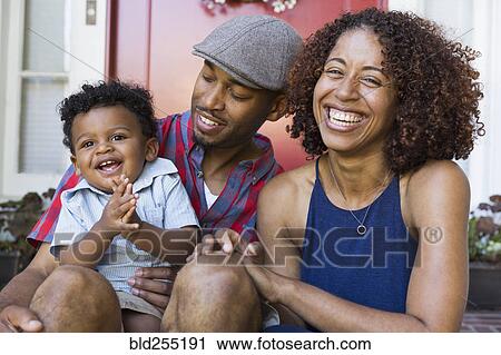 Laughing mixed race couple sitting on front stoop with son View Large Photo Image Stock Image - Laughing mixed race couple sitting on front stoop with son. Fotosearch
