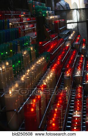 Stock Photo - Lit candles in church. Fotosearch