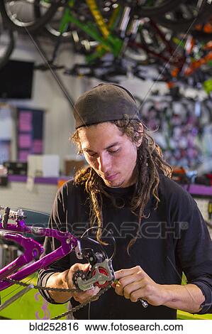 Man repairing bicycle in shop View Large Photo Image Stock Photograph - Man repairing bicycle in shop. Fotosearch