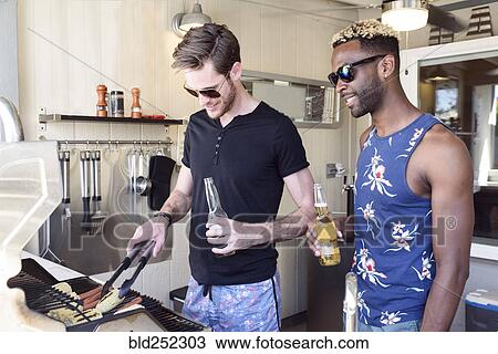 Men drinking beer and cooking on grille outdoors View Large Photo Image Stock Image - Men drinking beer and cooking on grille outdoors. Fotosearch