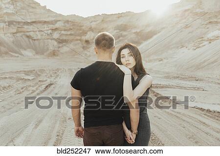 Stock Photo - Middle Eastern couple hugging in the desert. Fotosearch
